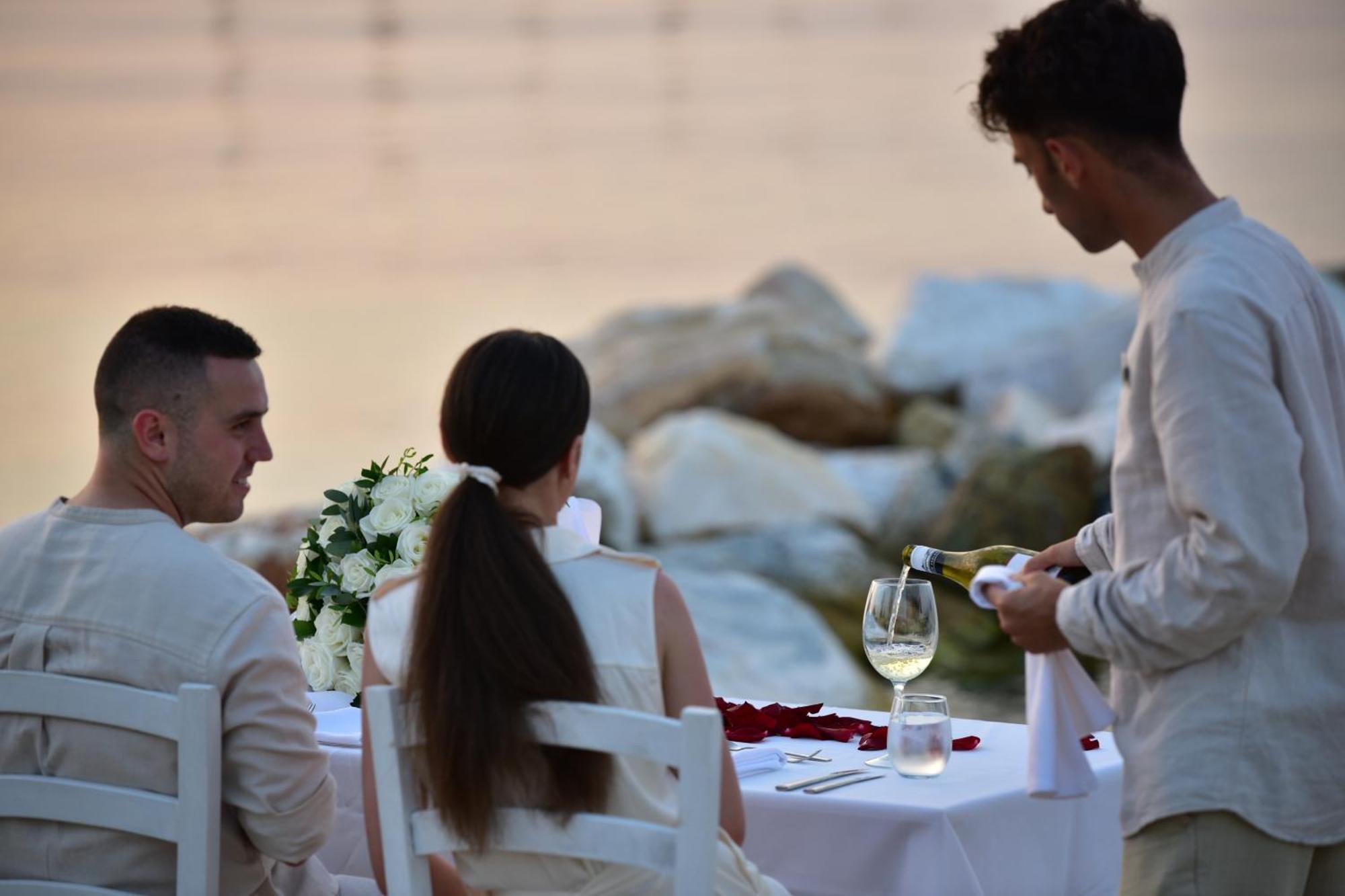 Miraggio Thermal Spa Resort Paliouri Exterior photo A waiter serving wine